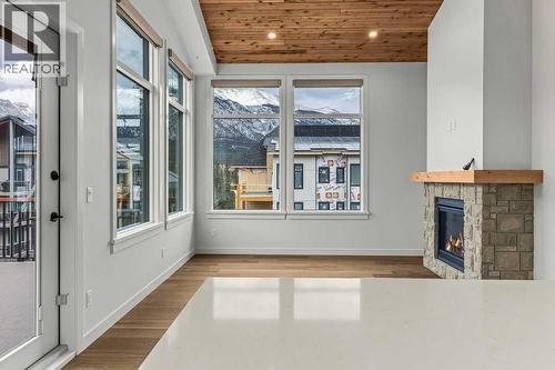 407, 1505 Spring Creek Gate, Canmore, AB - Indoor With Fireplace