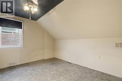 Additional living space featuring vaulted ceiling and a ceiling fan - 