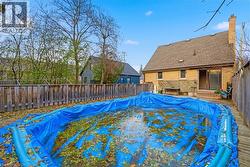 View of swimming pool featuring a fenced backyard and a wooden deck - 