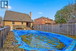 View of swimming pool with a fenced backyard and a wooden deck - 