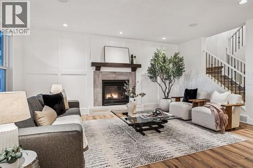 47 Sundown Way, Cochrane, AB - Indoor Photo Showing Living Room With Fireplace
