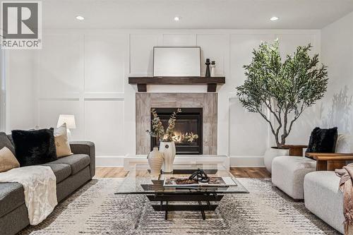47 Sundown Way, Cochrane, AB - Indoor Photo Showing Living Room With Fireplace