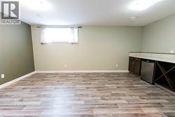 Large rec/games room in basement with custom wet bar - 