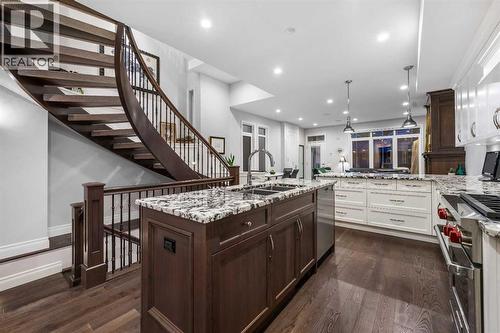"Floating" Grand Spiral Staircase - 922 5 Street Nw, Calgary, AB - Indoor Photo Showing Kitchen With Double Sink With Upgraded Kitchen