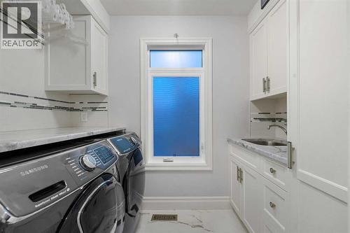 Laundry conveniently located on 2nd level with bedrooms - 922 5 Street Nw, Calgary, AB - Indoor Photo Showing Laundry Room