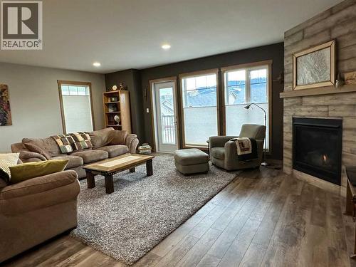 67 Ironstone Drive, Coleman, AB - Indoor Photo Showing Living Room With Fireplace