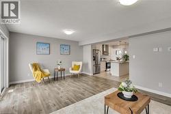 Living room with light wood-type flooring and baseboards - 