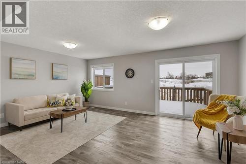 Living room with wood finished floors and a textured ceiling - 492 Wismer Street, Waterloo, ON - Indoor Photo Showing Living Room
