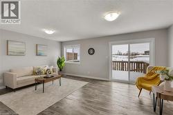 Living room with wood finished floors and a textured ceiling - 