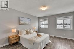 Bedroom with wood finished floors and a textured ceiling - 
