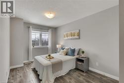 Bedroom featuring light wood-style flooring and a textured ceiling - 