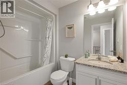 Bathroom with vanity and shower / bath combination with curtain - 