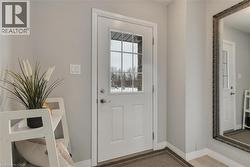 Doorway featuring baseboards and wood finished floors - 