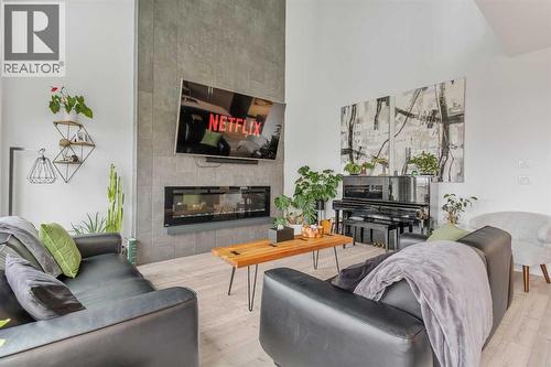 668 Aquitania Boulevard W, Lethbridge, AB - Indoor Photo Showing Living Room With Fireplace