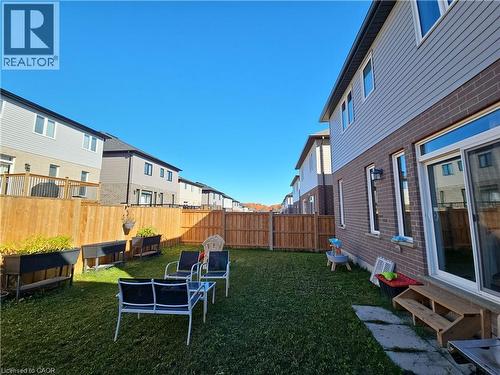 Fenced backyard featuring a residential view and entry steps - 293 Chokecherry Crescent, Waterloo, ON - Outdoor With Exterior