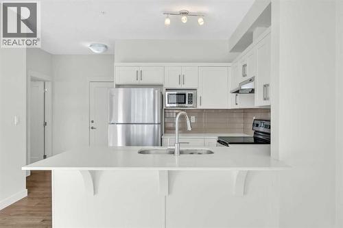 211, 10 Walgrove Walk Se, Calgary, AB - Indoor Photo Showing Kitchen With Upgraded Kitchen