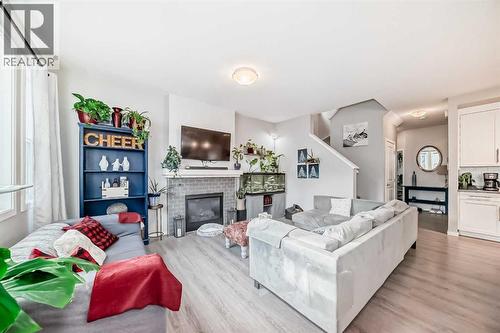 325 Sundown View, Cochrane, AB - Indoor Photo Showing Living Room With Fireplace