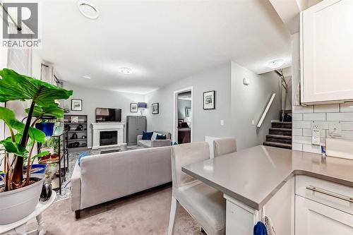 325 Sundown View, Cochrane, AB - Indoor Photo Showing Living Room With Fireplace