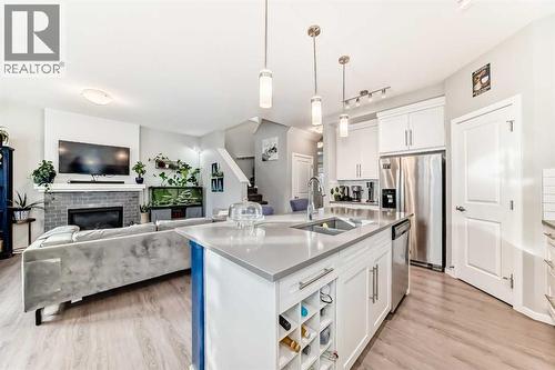 325 Sundown View, Cochrane, AB - Indoor Photo Showing Kitchen With Fireplace With Double Sink With Upgraded Kitchen