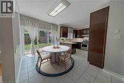 Dining room with baseboards, light tile patterned floors, and recessed lighting - 