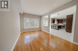 Unfurnished living room with baseboards, light wood-type flooring, recessed lighting, and a sink - 
