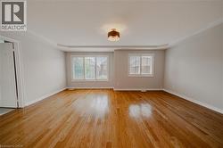 Unfurnished room featuring light wood-type flooring, baseboards, and a textured ceiling - 