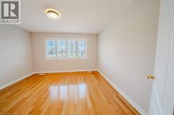 Empty room featuring light wood-style floors and baseboards - 