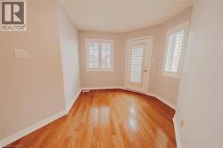 Empty room with light wood finished floors and baseboards - 