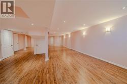 Spare room featuring light wood-type flooring, baseboards, and recessed lighting - 