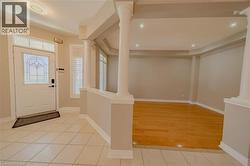 Entryway featuring ornate columns, light wood finished floors, recessed lighting, and baseboards - 