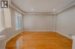 Unfurnished room with light wood finished floors, recessed lighting, and baseboards - 