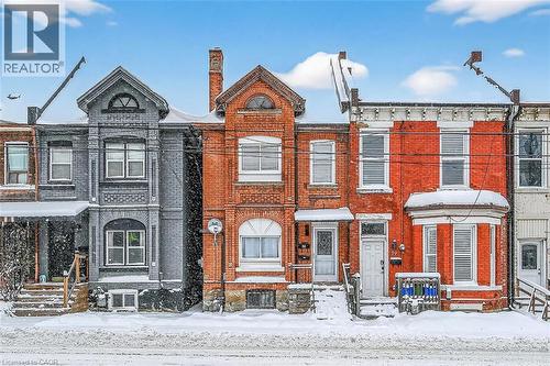 View of front facade featuring brick siding and a chimney - 77 Barton Street E Unit# 1, Hamilton, ON - Outdoor With Facade