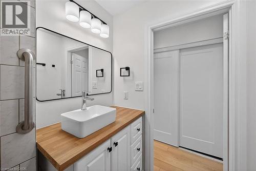 Bathroom featuring vanity and light wood finished floors - 77 Barton Street E Unit# 1, Hamilton, ON - Indoor Photo Showing Other Room