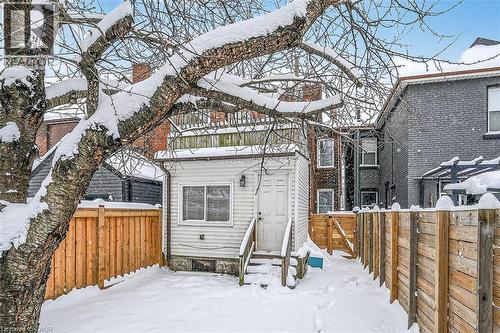 Snow covered property with a fenced backyard, a gate, and entry steps - 77 Barton Street E Unit# 1, Hamilton, ON - Outdoor