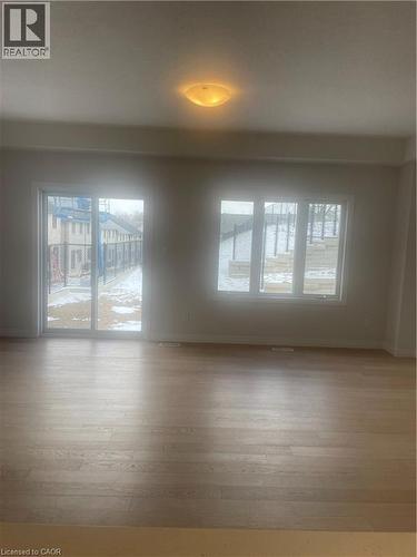 Empty room featuring plenty of natural light and light wood-style floors - 152 Queensbrook Crescent, Cambridge, ON - Indoor Photo Showing Other Room
