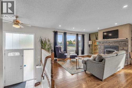 9883 Athens Road Se, Calgary, AB - Indoor Photo Showing Living Room With Fireplace