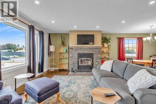 9883 Athens Road Se, Calgary, AB - Indoor Photo Showing Living Room With Fireplace
