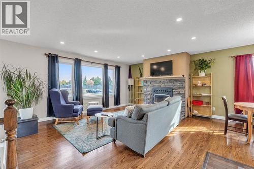 9883 Athens Road Se, Calgary, AB - Indoor Photo Showing Living Room With Fireplace