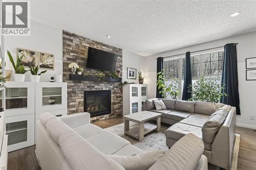 105 Riviera Crescent, Cochrane, AB - Indoor Photo Showing Living Room With Fireplace