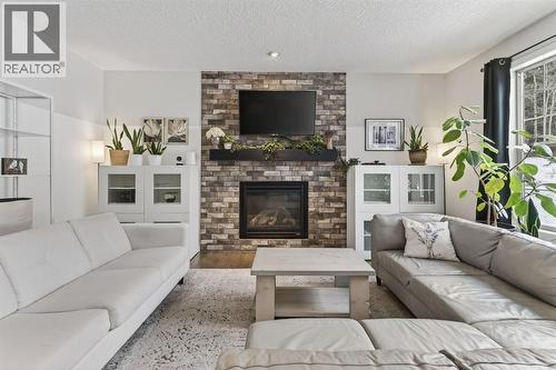 105 Riviera Crescent, Cochrane, AB - Indoor Photo Showing Living Room With Fireplace