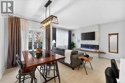 43 Chaparral Valley Common Se, Calgary, AB - Indoor Photo Showing Dining Room With Fireplace