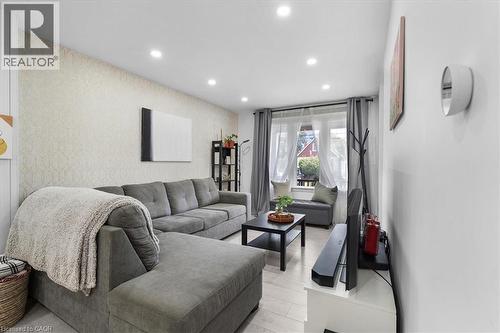Living room featuring wallpapered walls, recessed lighting, an accent wall, and light wood finished floors - 133 Frederick Avenue, Hamilton, ON - Indoor Photo Showing Other Room
