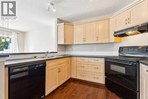 73 Rocky Ridge Heath Nw, Calgary, AB - Indoor Photo Showing Kitchen With Double Sink