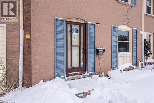 Snow covered property entrance featuring brick siding - 27 Queenston Drive, Kitchener, ON - Outdoor