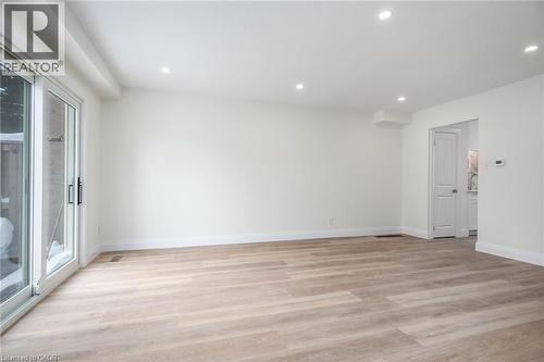 Empty room with light wood-style floors and recessed lighting - 27 Queenston Drive, Kitchener, ON - Indoor Photo Showing Other Room