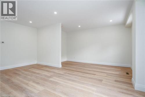 Empty room with light wood-style floors and recessed lighting - 27 Queenston Drive, Kitchener, ON - Indoor Photo Showing Other Room