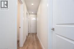 Corridor featuring light wood-style flooring and recessed lighting - 