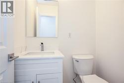Half bathroom featuring vanity and toilet - 