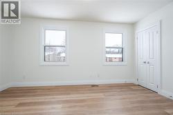 Unfurnished bedroom featuring light wood-style floors and a closet - 