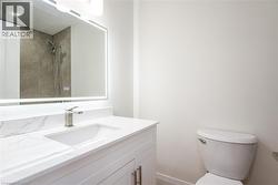 Bathroom with vanity and tiled shower - 